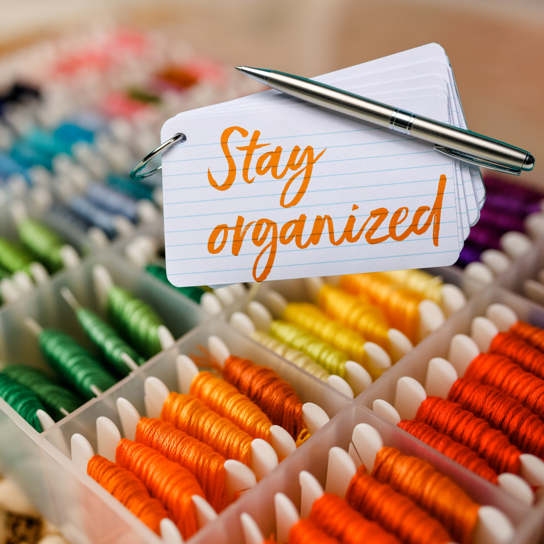 an open drawer with many threads in different colors all organized per color