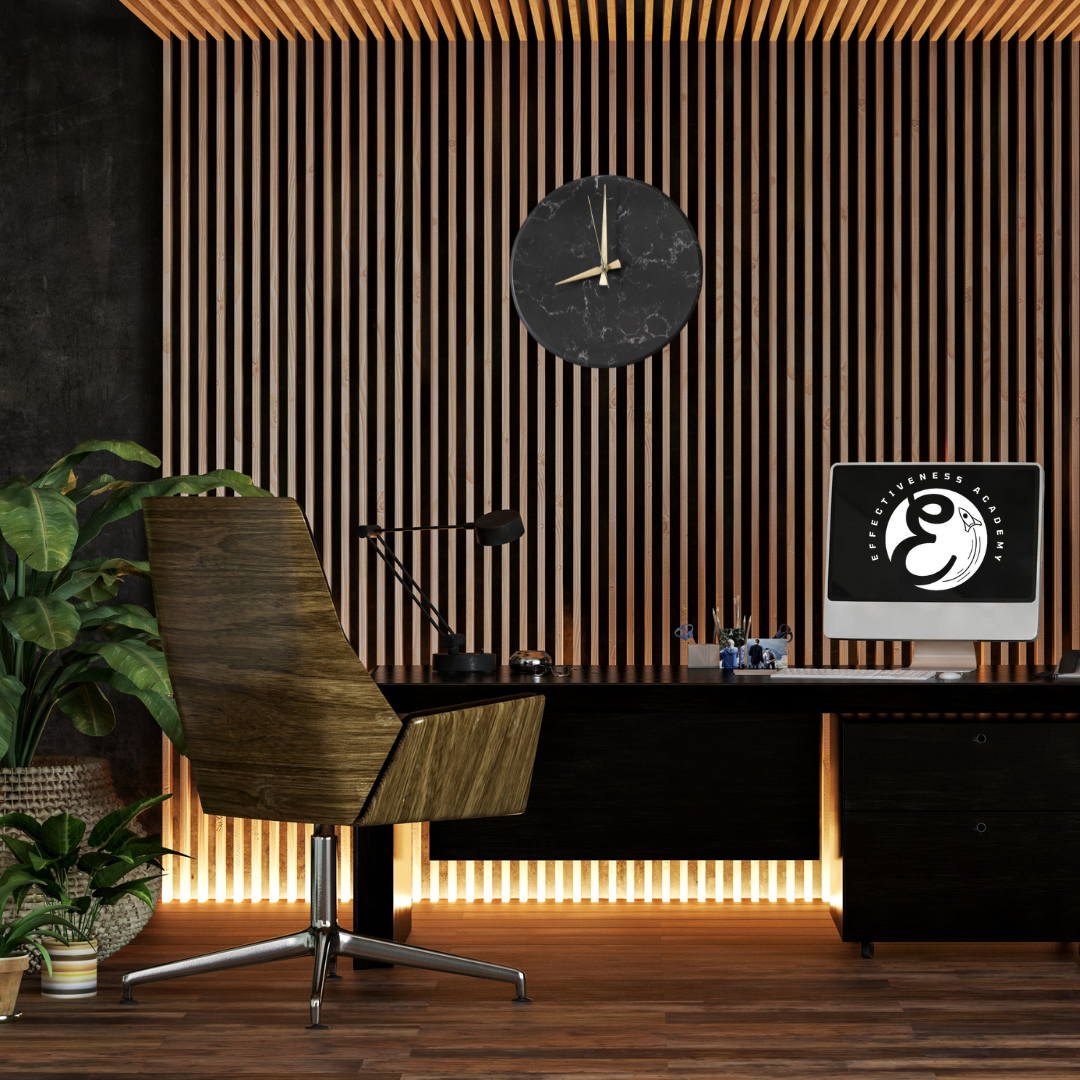 a modern and luxurious office with a sleek designed desk with a computer and screen on it, logo of effcitiveness academy is a on screen, above on a wall hangs a marble black clock