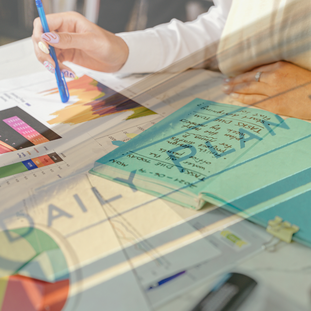 woman doing a daily planning in agenda with project papers lying around her